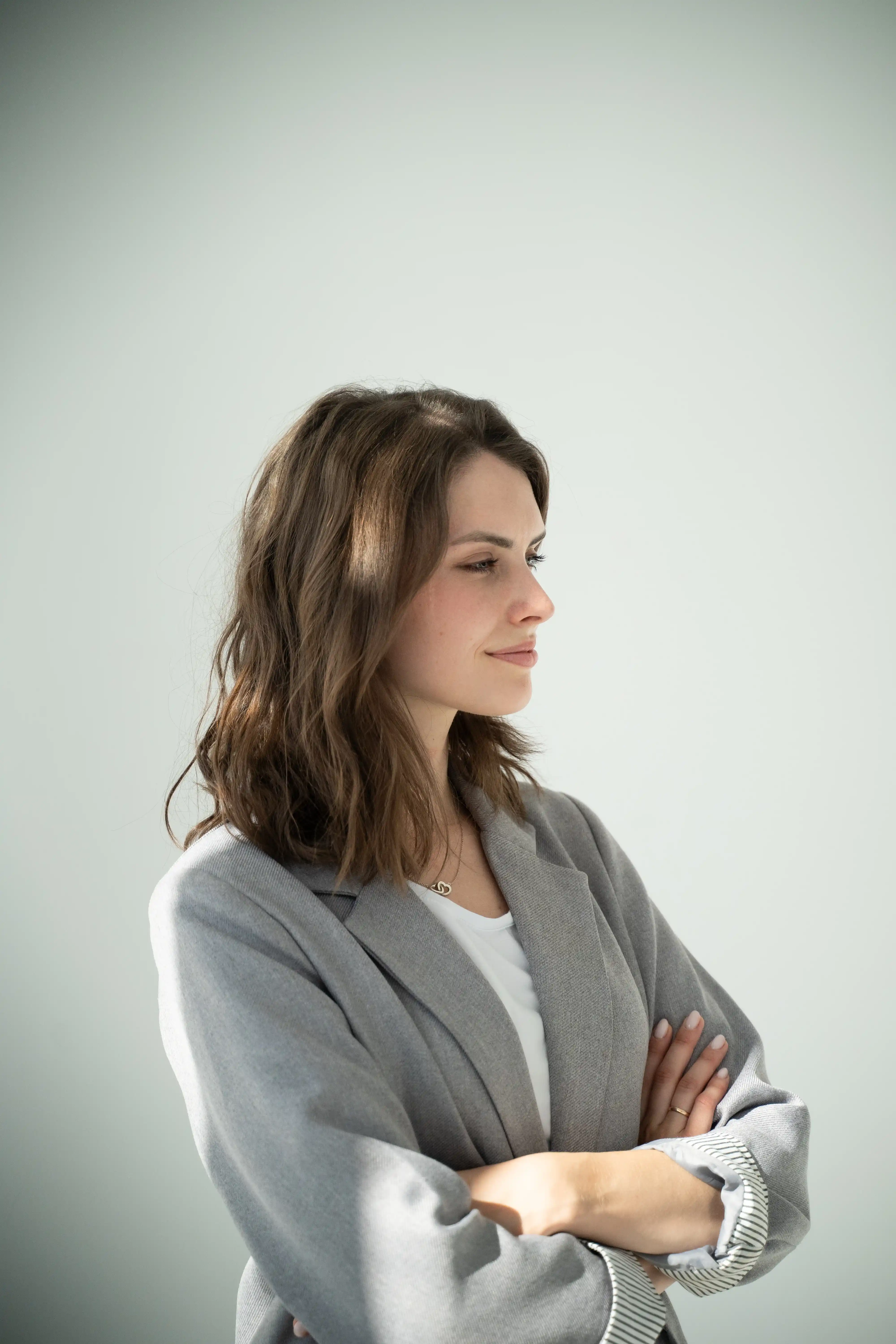 A young girl with brown hair crossed her arms
